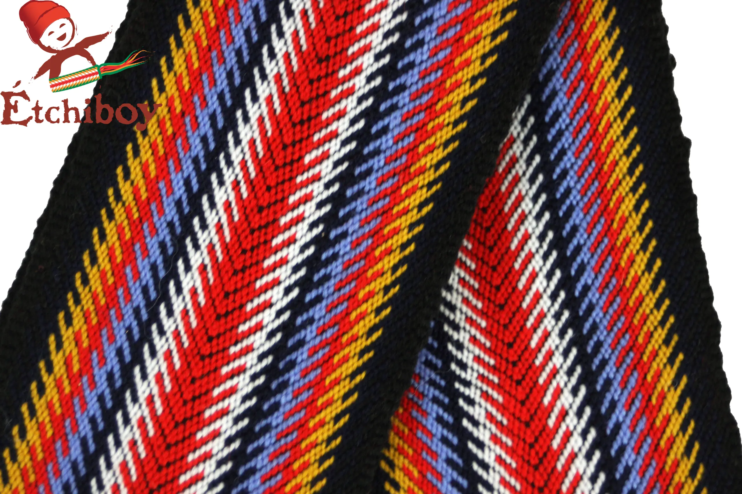 This sash is handmade on a loom using alpaca wool. Its origins trace back to circa 1885, the time of the Battle of Batoche. This sash is a Métis version of the L’Assomption sash with a black border replacing the red in order to represent the “Dark Times”. This period started around 1870 – 1885 when the Métis were considered “traitors” and had to hide their identity for over a hundred years. Cette ceinture fléchée est faite à la main sur un métier utilisant de la laine d’alpaga. Ses origines se retracent aux environs de 1885, le temps de la bataille de Batoche. Cette ceinture fléchée est une réplique de la ceinture fléchée de L’Assomption mais avec une bordure noire au lieu de rouge pour représenter le “Temps noir”. Ce temps noir a commencé vers 1870 à 1885 quand les Métis ont été traités de « traitres » et ils devaient se cacher pour plus de 100 ans pour survivre.